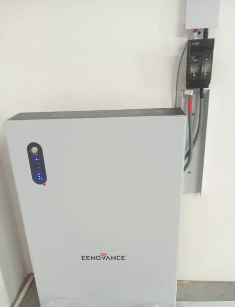 A wall-mounted battery cabinet beside its isolator switch and conduit